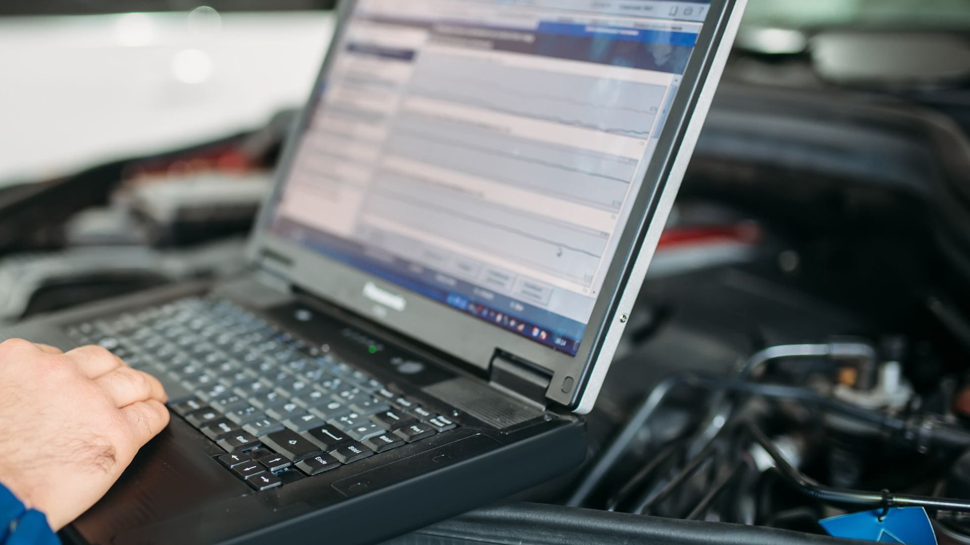 A close up of a person typing on a laptop